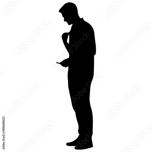 Silhouette of a man looking at his phone.