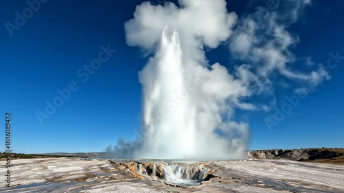 Wallpaper Mural Geyser erupting with water and steam into a clear blue sky, showing the powerful natural phenomenon Torontodigital.ca