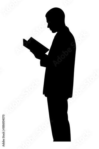 Silhouette of man reading book while standing