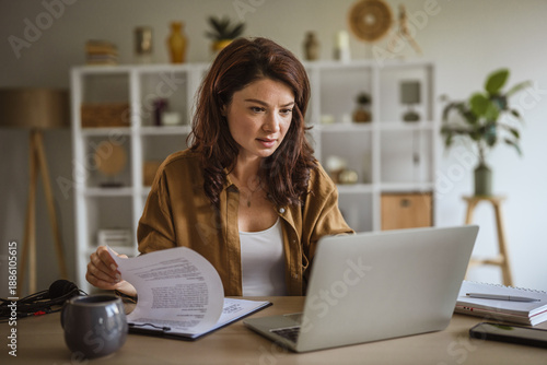 Bilde på lerret Woman working remotely at home office reviewing documents