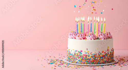 Birthday Celebration, Cake with Candles, Pink Background, Photo, Festive Environment, Close-Up View, Joyful Concept