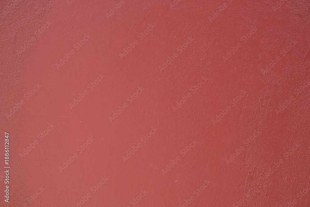 Fototapeta premium Close-up texture of a smooth, matte, dusty rose colored surface with subtle imperfections