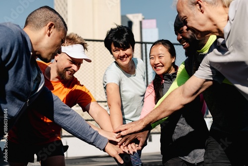 Konstfotografi Diverse group of people in sportswear, hands in, showing teamwork and unity