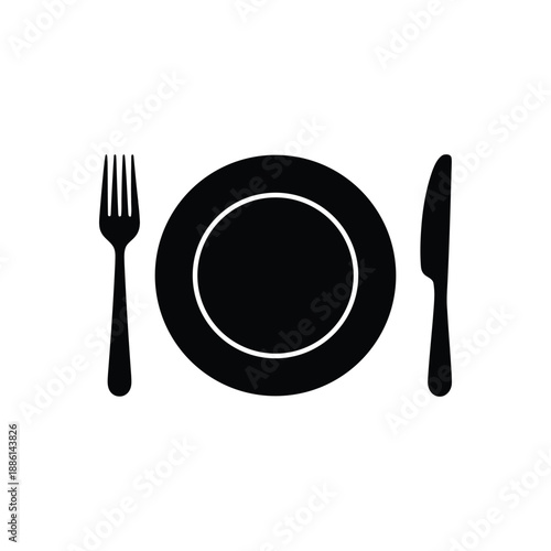 Dinner table setting with a metal fork, knife, and spoon as a complete set of silverware cutlery for a restaurant meal