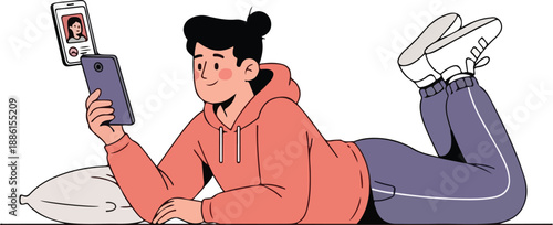 Young woman relaxing on a couch while video chatting on her smartphone with a friend