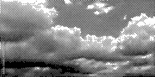 A grainy black and white image depicting clouds and a blurred landscape