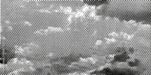 Abstract grayscale texture displaying a dotted grainy and mottled pattern