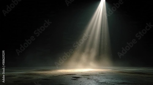 Dramatic theatrical spotlight beam piercing through dark smoky environment, creating a focused illumination on textured ground