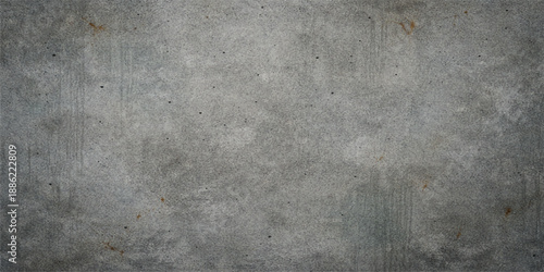 A dark and aged grunge concrete wall texture featuring a rough grey cement surface with a dirty vintage stone pattern and weathered paint backdrop
