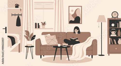 Young woman relaxing on a comfortable sofa reading a book.
