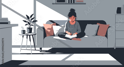 Young woman sitting on sofa writing in notebook.