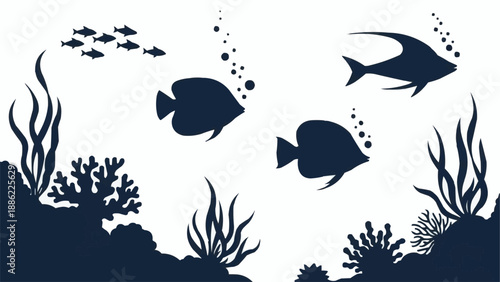 Silhouette of tropical fish swimming in coral reef underwater.