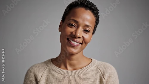 Smiling young woman with short hair looking directly at camera