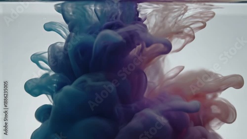 Vibrant ink swirling in water creating mesmerizing fluid patterns