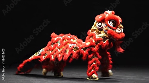 Vibrant red lion dance costume on display against black background