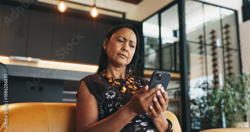 Confused, woman and doubt in home with phone, unexpected news and text message for online gossip. Mature person, concern and reading in house with tech, mobile chat and update for social media rumor.