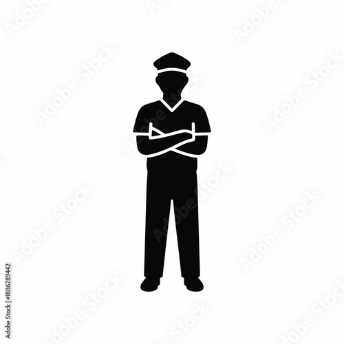 A sailor stands confidently with crossed arms wearing a sailor's uniform