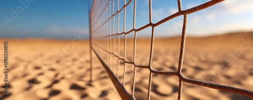 Volleyball Net Strategy concept. Volleyball net against a sandy beach backdrop under a clear blue sky.