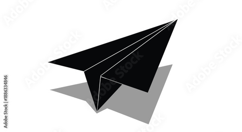 A simple black paper airplane casting a shadow on a white surface