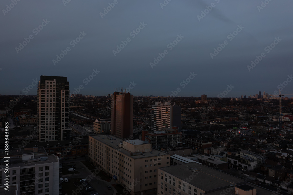 Fototapeta premium Toronto cityscape showcasing residential and commercial buildings under a muted evening sky, capturing urban life and architectural diversity in ontario, canada