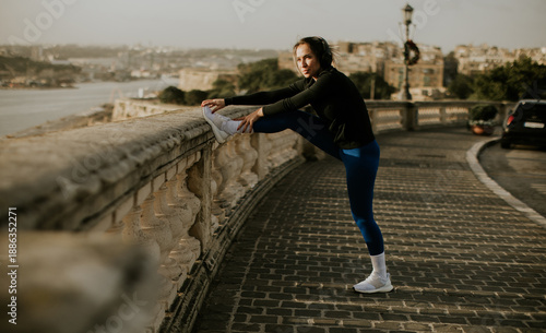 Woman stretches while exerc...