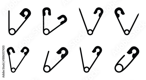 A collection of black and white safety pins arranged in a grid pattern