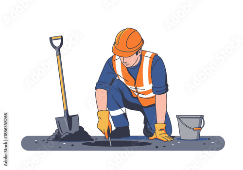 Professional construction worker in a safety vest and hard hat carefully digging a trench for pipeline repair and maintenance