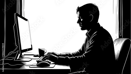 Man working on computer in silhouette.