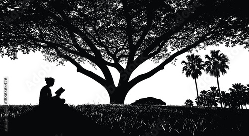 Silhouette of a young woman sitting alone under a massive tree and reading a book in a peaceful meadow at sunset