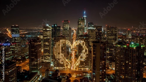 Wallpaper Mural A city skyline at night where windows gradually light up to form a glowing heart shape Torontodigital.ca
