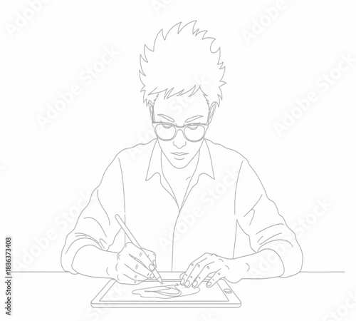 A focused young man with glasses intently drawing on a graphic tablet with a stylus