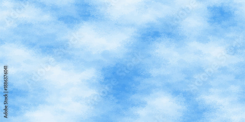 A beautiful clear blue sky background filled with fluffy white cumulus clouds creates a natural summer cloudscape and a bright sunny atmosphere in the light air of a peaceful day