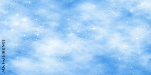Beautiful blue winter sky background with fluffy white clouds and snowflakes over a clear natural atmosphere