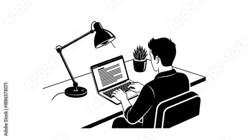 Man working on laptop at desk with lamp and plant.