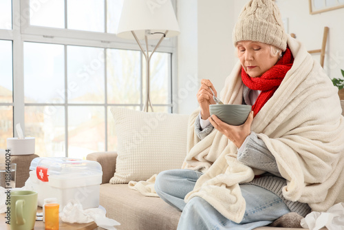 Sick elderly woman eating s...