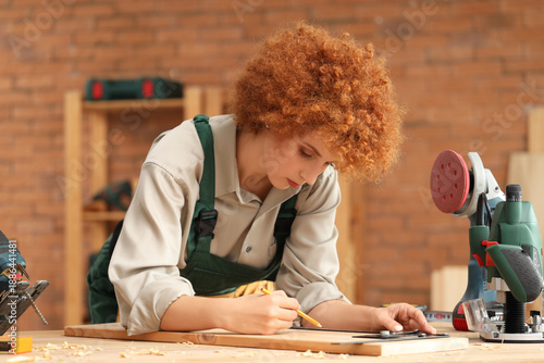 Young female carpenter mark...