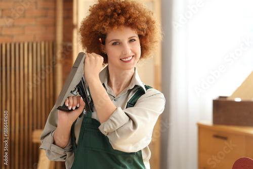 Young female carpenter with...