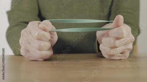 Stretching a green elastic rubber band