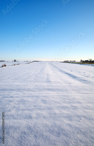 A farm field covered with snow in winter.