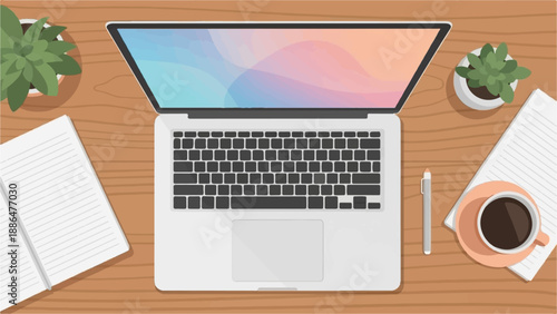 Overhead view of a desk with an open laptop, notebook, pen, and coffee cup