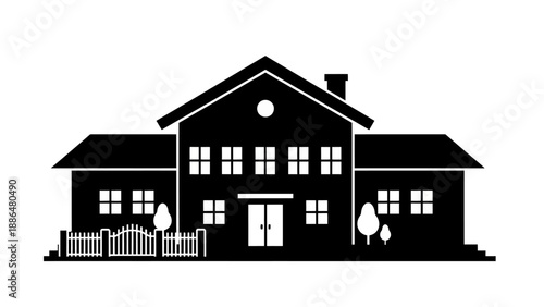 Silhouette of a large suburban house with a fence and trees.