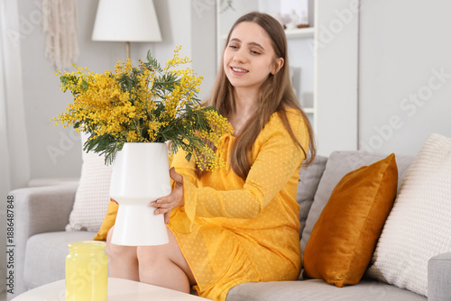 Young woman with mimosa flo...