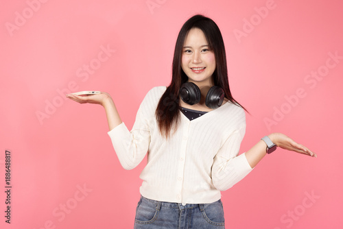 Happy Thai smiling confident A woman is holding up two hands, one of which is in the air