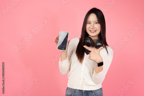Happy Thai smiling confident A woman is holding a cell phone and pointing to it