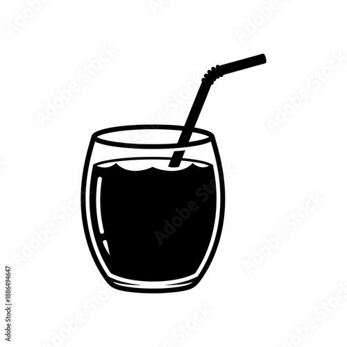 Refreshing dark beverage in a glass with a straw