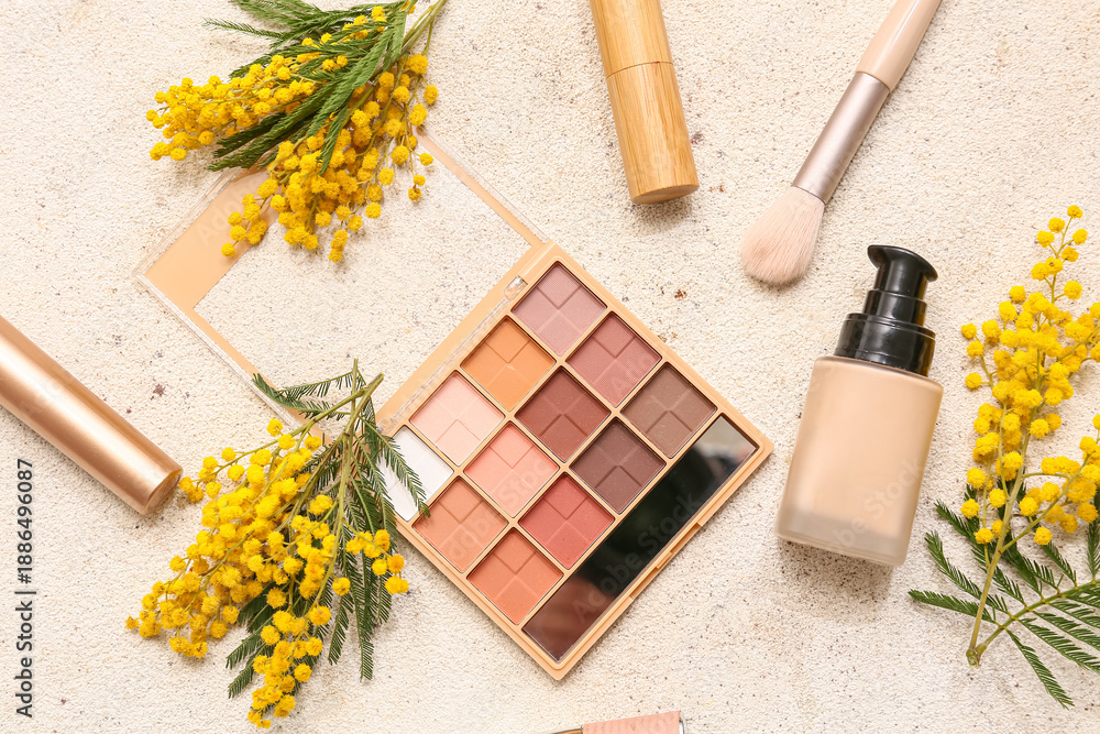 Naklejka premium Decorative cosmetics and mimosa flowers on white background