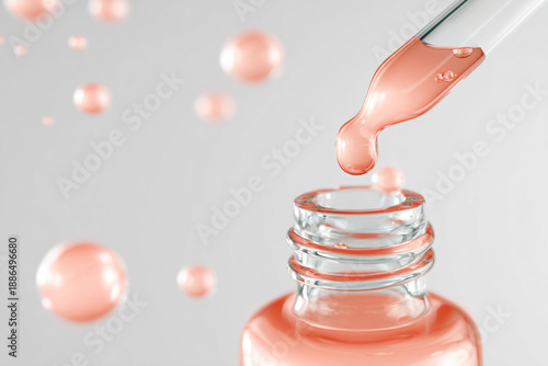 Serum dripping from pipette into glass bottle with peach liquid