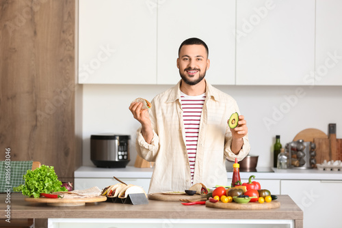 Young man preparing tasty M...