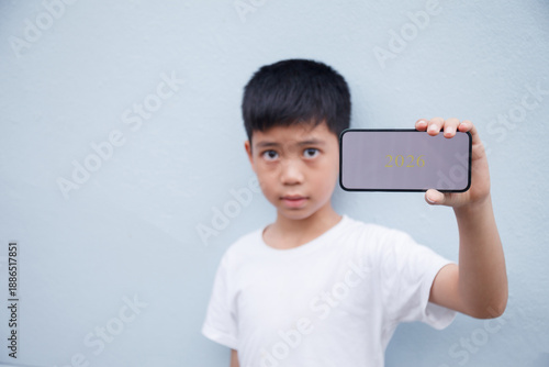 The child is showing a smartphone in their hand with the message 