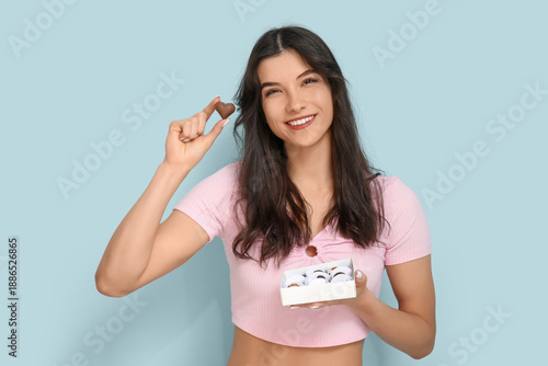 Happy young woman with box ...